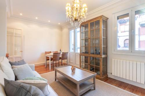 a living room with a couch and a table at Bilbao Costa by Aston Rentals in Getxo