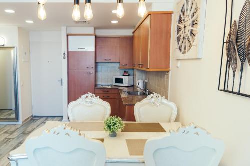 a kitchen and dining room with a table and chairs at Almog Haifa Israel Apartments מגדלי חוף הכרמל in Haifa