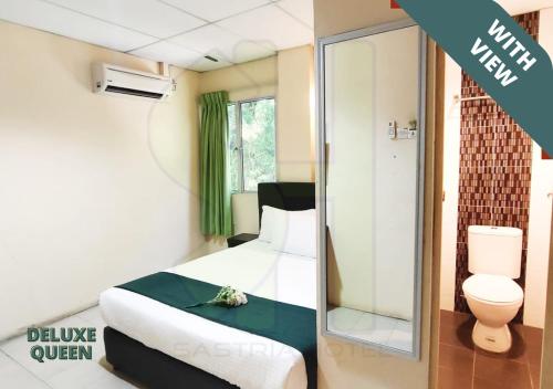 Ένα ή περισσότερα κρεβάτια σε δωμάτιο στο Sastria Hotel Sungai Petani
