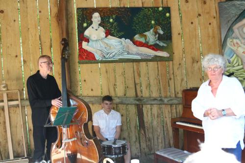 a man and a woman and a boy and a violin at Ropuszy Dwór in Żerdenka
