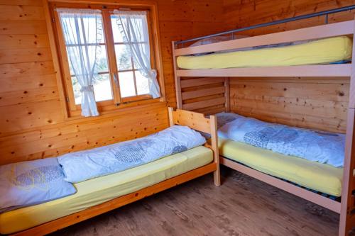 a room with two bunk beds in a cabin at Chalet Valeria in Rosswald
