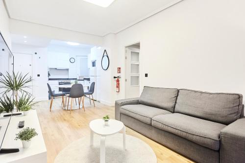 a living room with a couch and a table at Izpizua Apartment in San Sebastián