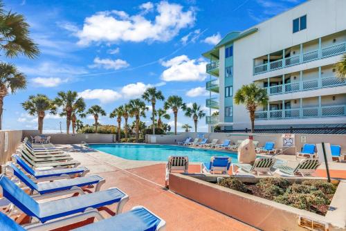 a swimming pool with lounge chairs and a resort at 1BR Ocean Forest Plaza Condo w Breathtaking Views in Myrtle Beach