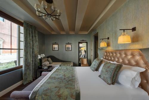 a bedroom with a large bed and a couch at Palazzo Veneziano - Venice Collection in Venice