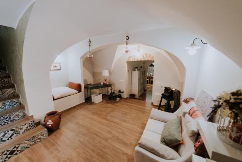 a living room with a white couch and a staircase at La casa di Achille in Chieti