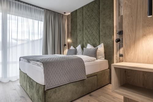 1 dormitorio con cama y ventana grande en Perfect Lodgings Panorama Hart, en Hart im Zillertal