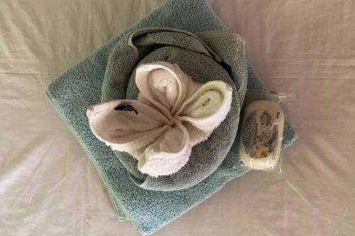 a towel with a flower on top of a bed at Bungalow 1 on this world renowned Eco site 40 minutes from Vic Falls Fully catered stay - 1978 in Victoria Falls