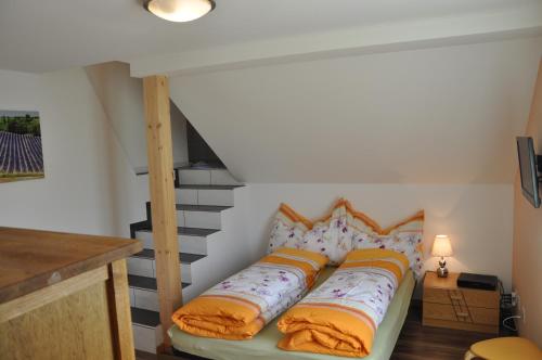 a bed in a room with a staircase at Hirschfarm, Goldau in Goldau