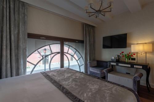 a bedroom with a bed and a sliding glass door at Palazzo Veneziano - Venice Collection in Venice