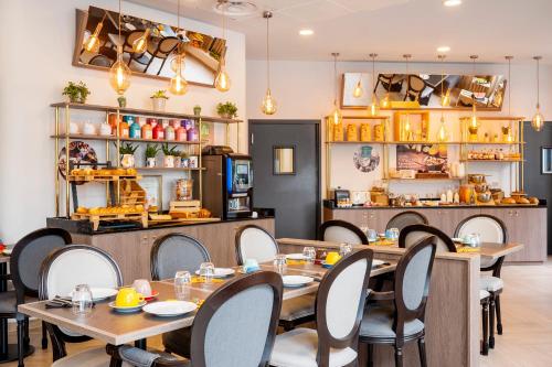 un restaurant avec des tables, des chaises et un comptoir dans l'établissement Residhome Paris Clamart, à Clamart
