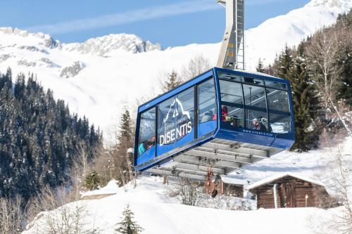 a ski lift with people on it in the snow at Catrina Hotel in Disentis