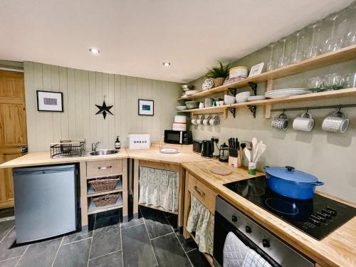 a kitchen with wooden counters and a stove top oven at Old Pier Cottage Tarbert in Tarbert