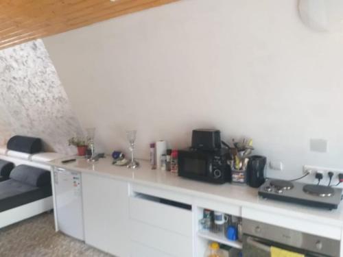 a kitchen with a white counter top with a stove at Popasul Dacilor in Predeluţ