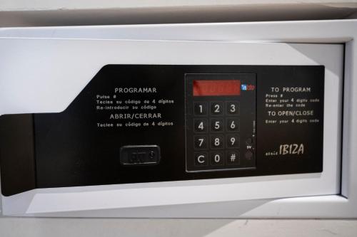 a microwave oven with a digital clock on it at YOU & CO. Saler Beach Boutique in Valencia
