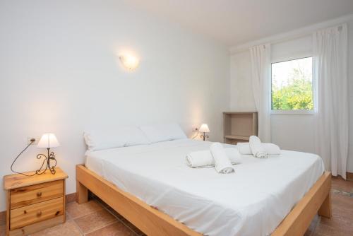 a bedroom with a large white bed and a window at Rodriguez De La Fuente 19 (Sin Nombre) in Playa de Muro