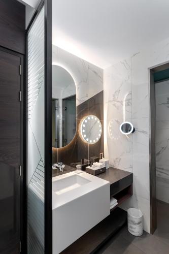 a bathroom with a sink and a mirror at Hyatt Centric Jumeirah Dubai in Dubai