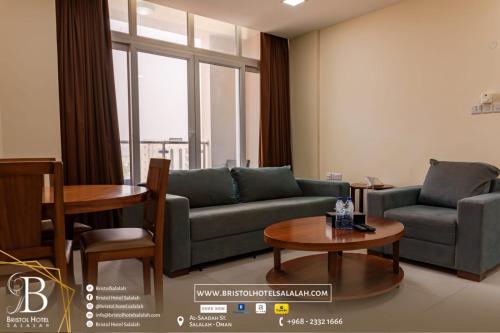 a living room with a couch and a table at Bristol Hotel Salalah in Salalah