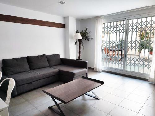a living room with a couch and a coffee table at Flats Friends Tetuan in Valencia