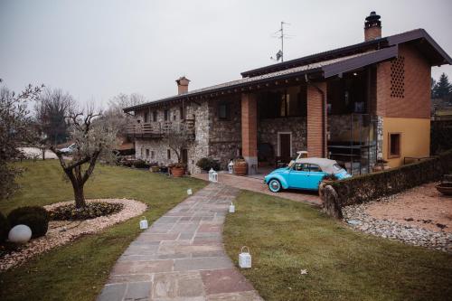 een blauwe auto geparkeerd voor een huis bij Agriturismo Molino dei Frati in Trescore Balneario