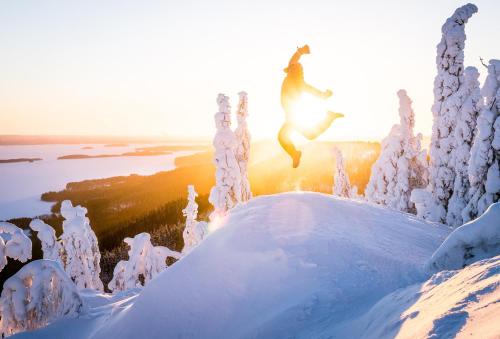 a person jumping in the air in the snow at Break Sokos Hotel Koli in Kolinkylä