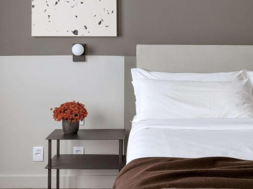 a bed with a white comforter and pillows on it at Caesar Business Belo Horizonte Belvedere in Belo Horizonte