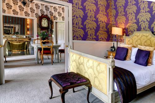 a bedroom with a bed and a table in a room at The Swan Hotel, Wells, Somerset in Wells