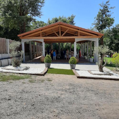 a wooden pavilion with people standing under it at Hotel Conde in Taboadela
