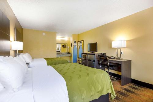 a hotel room with a bed and a desk at Quality Inn Mobile West Tillmans Corner in Tillmans Corner