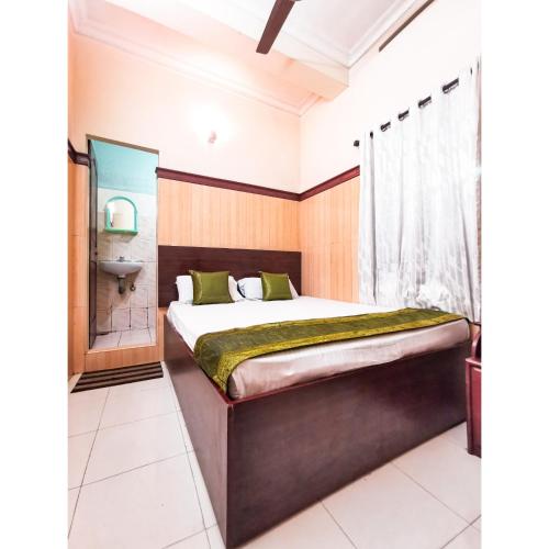 a bedroom with a bed and a toilet and a sink at New AS Tourist Home Aluva in Cochin
