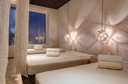 a bedroom with two beds and a window at Radisson Collection Hotel, Old Mill Belgrade in Belgrade