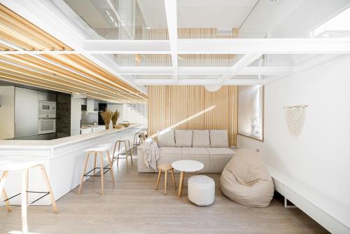 a living room with a couch and a table and chairs at White Fox - sauna - in Lviv