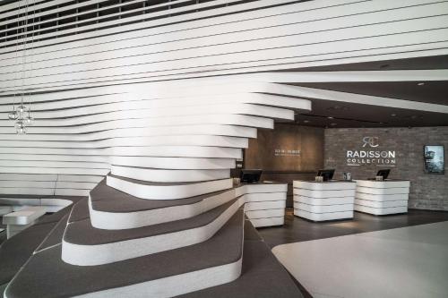 a lobby with a wall with a staircase in it at Radisson Collection Hotel, Old Mill Belgrade in Belgrade