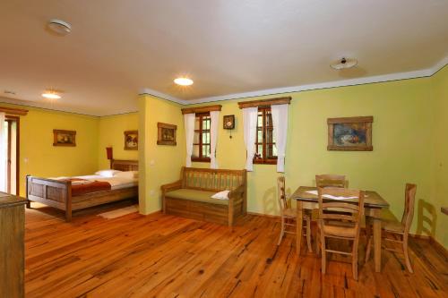a bedroom with a table and a bed and a dining room at Pomona Relaxing Nature Guest House in Rogaška Slatina
