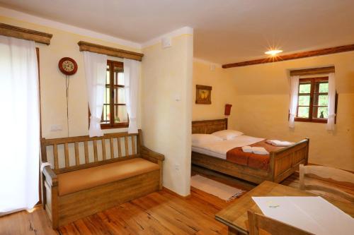 a bedroom with a bed and a desk and a table at Pomona Relaxing Nature Guest House in Rogaška Slatina