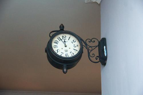 a clock hanging on the side of a wall at MINA CHAI HOUSE BNB in Arusha
