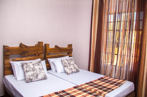 Ένα ή περισσότερα κρεβάτια σε δωμάτιο στο MINA CHAI HOUSE BNB