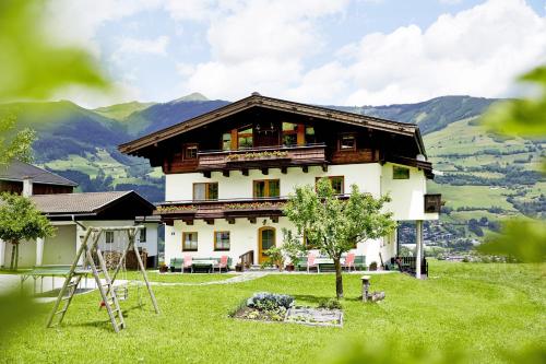 a large house on top of a green field at Vordergugg in Mittersill