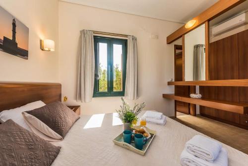 a bedroom with a bed with a tray on it at Margarita's Villas in Chania Town