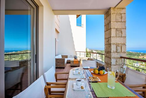 a dining room with a table and a view of the ocean at Margarita's Villas in Chania Town