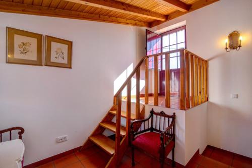 a wooden staircase in a room with a window at Villa Oliva Al ii in Moncarapacho