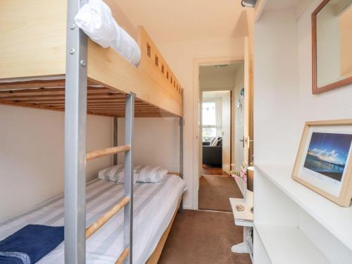 a bunk bed room with two bunk beds and a hallway at Seashell Cottage Lodge 97 in Deal