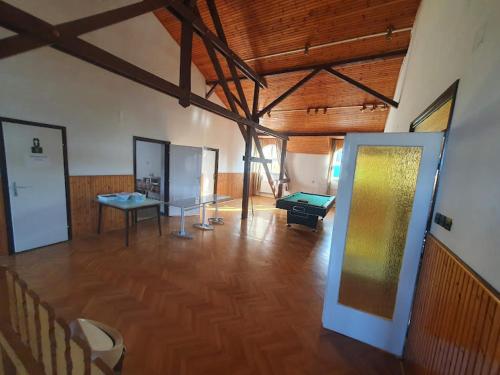 una grande camera con una stanza con tavolo da biliardo di Nosztalgia Villa a Mezőkövesd