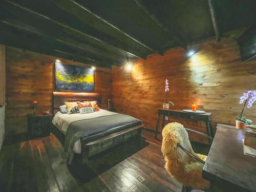 a bedroom with a bed and a wooden wall at La Gloria Reserva Forestal in La Calera
