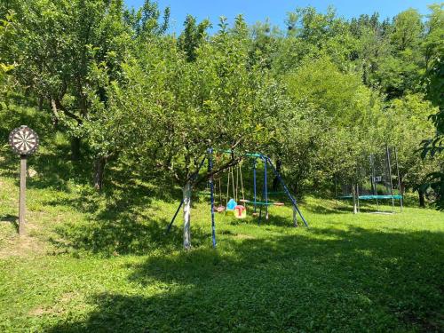 a playground in a park with a tree at Kuca za odmor Hiza i Vila in Krapina