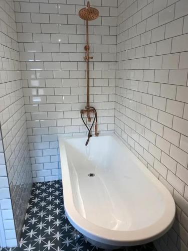 a white bath tub in a bathroom with stars at The Captains Nook-Hot tub in Amble