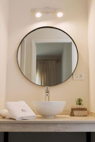 a bathroom with a sink and a mirror on a counter at El Castaño Apart in Potrerillos