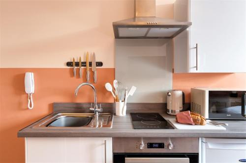 a kitchen with a sink and a microwave at Clifton House I Free Private Parking in Bristol