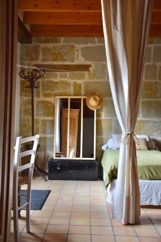 a bedroom with a bed and a window at Une pause nature chez Marion et Cédric in Montignac-Toupinerie