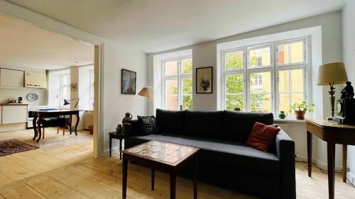 a living room with a couch and a table at ApartmentInCopenhagen Apartment 1466 in Copenhagen