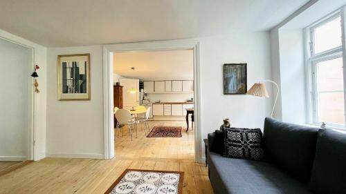 a living room with a couch and a dining room at ApartmentInCopenhagen Apartment 1466 in Copenhagen